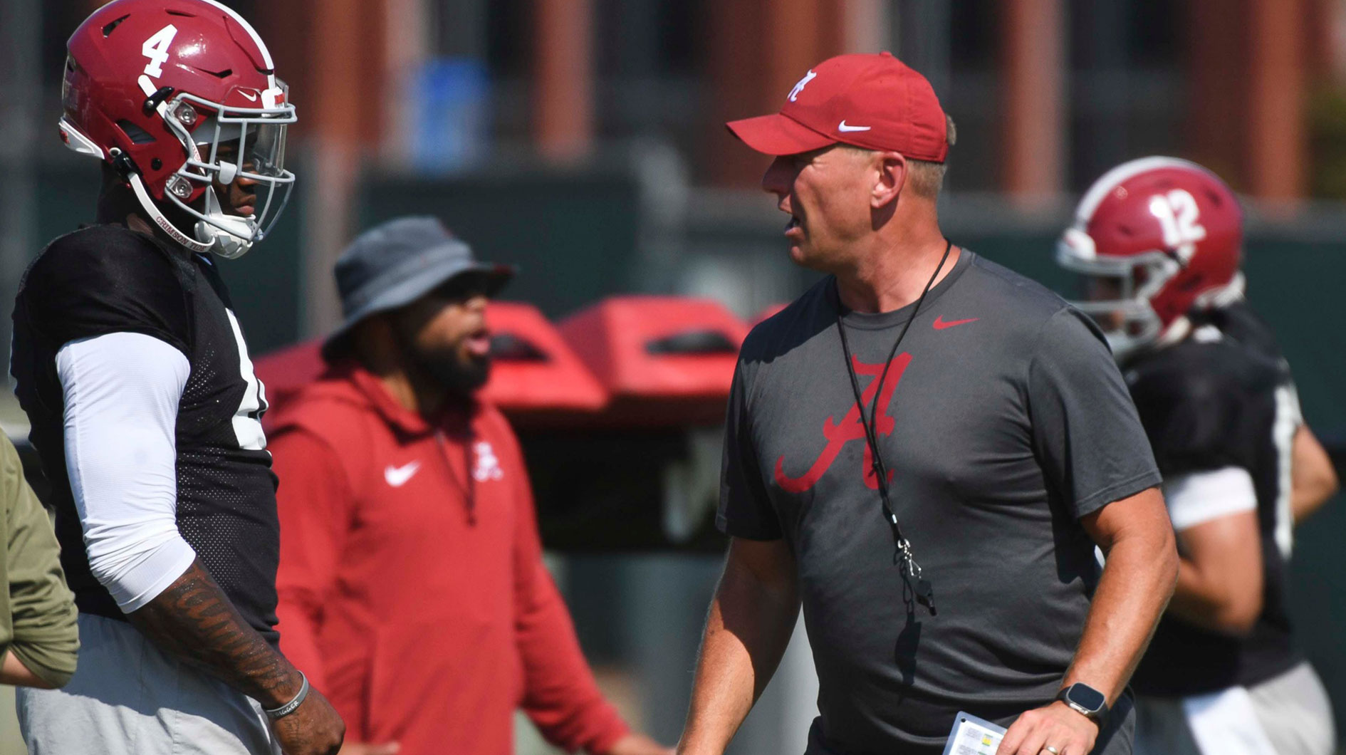 The Alabama Crimson Tide football team works out Sunday morning in practice as they prepare for the 2024 season. Alabama quarterback Jalen Milroe (4) listens to directions from Alabama head coach Kalen DeBoer.