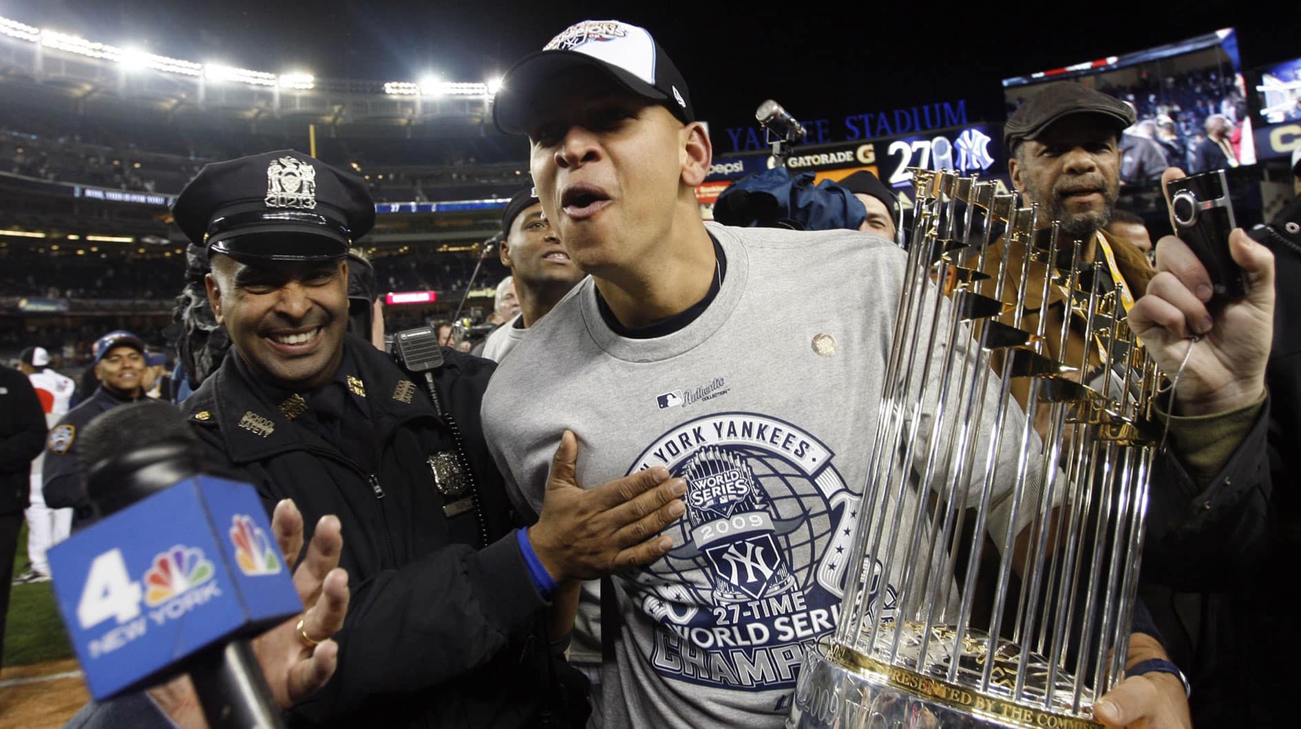  New York Yankees third baseman Alex Rodriguez carries the World Series championship trophy off the field after defeating the Philadelphia Phillies 7-3 in game six of the 2009 World Series at Yankee Stadium. 