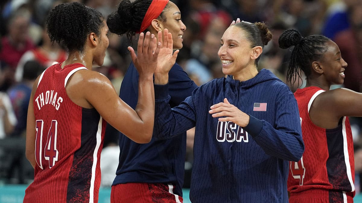 United States power forward Alyssa Thomas (14) and shooting guard Diana Taurasi (12) celebrate after defeating Germany in a women’s group C game during the Paris 2024 Olympic Summer Games.