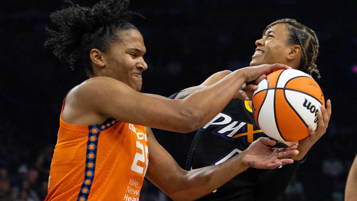 Phoenix Mercury guard Natasha Cloud (0) is contested on a shot by Connecticut Sun forward Alyssa Thomas