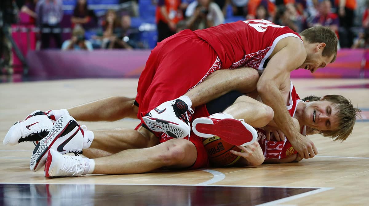 Russia forward Sergey Monya (12) and forward Andrei Kirilenko (15) celebrate after winning the bronze against Argentina in the men's bronze medal game during the London 2012 Olympic Games at Aquatics Centre.