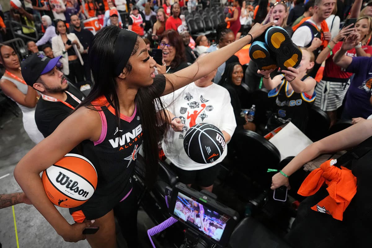 Team WNBA forward Angel Reese (5) hands off her shoes to a young fan after the WNBA All-Star Game at Footprint Center in Phoenix on July 20, 2024.