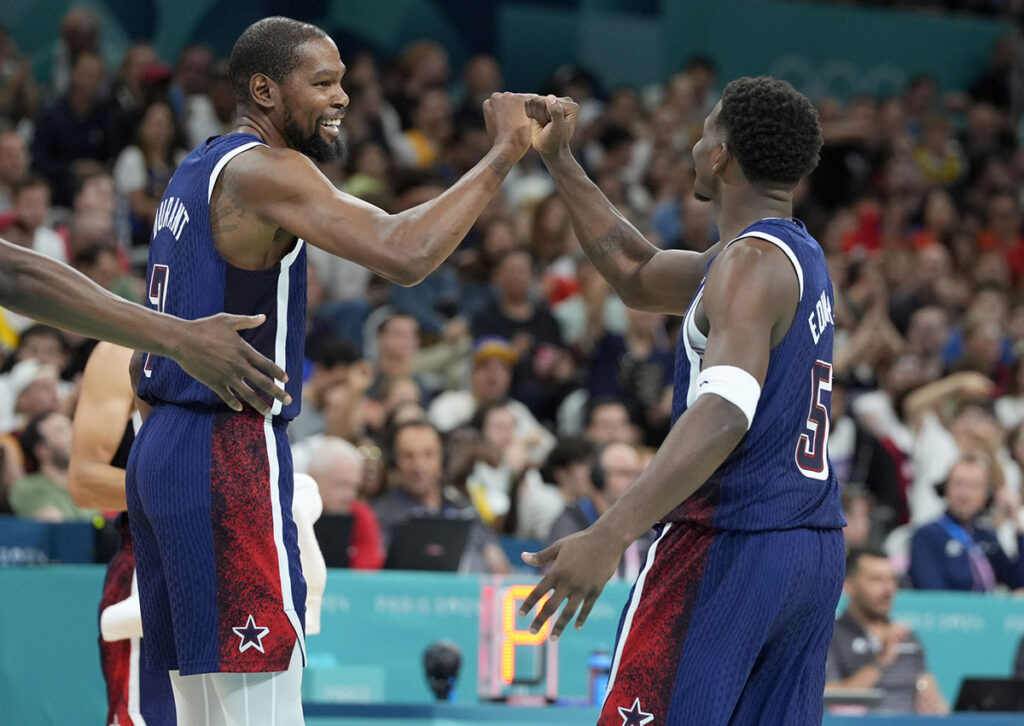 United States guard Kevin Durant (7) and guard Anthony Edwards (5) celebrate after a play in the third quarter against Serbia during the Paris 2024 Olympic Summer Games at Stade Pierre-Mauroy. 