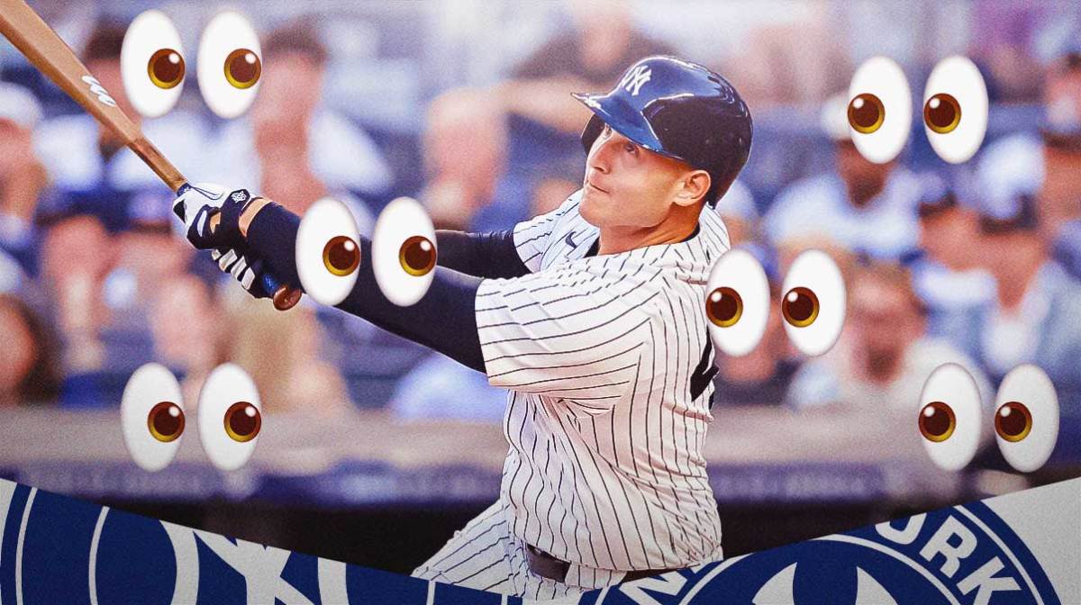Yankees' Anthony Rizzo hits ball while Cardinals and injury reporters watch