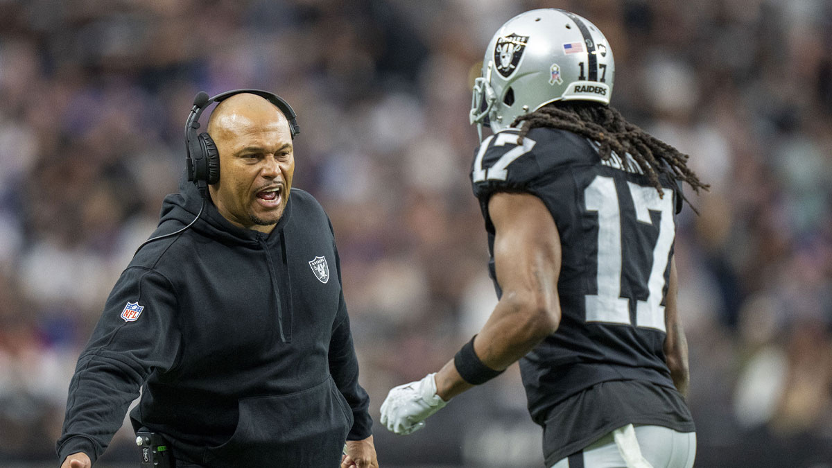 Las Vegas Raiders interim head coach Antonio Pierce (left) high-fives wide receiver Davante Adams (17) after a touchdown against the New York Giants during the first quarter at Allegiant Stadium.