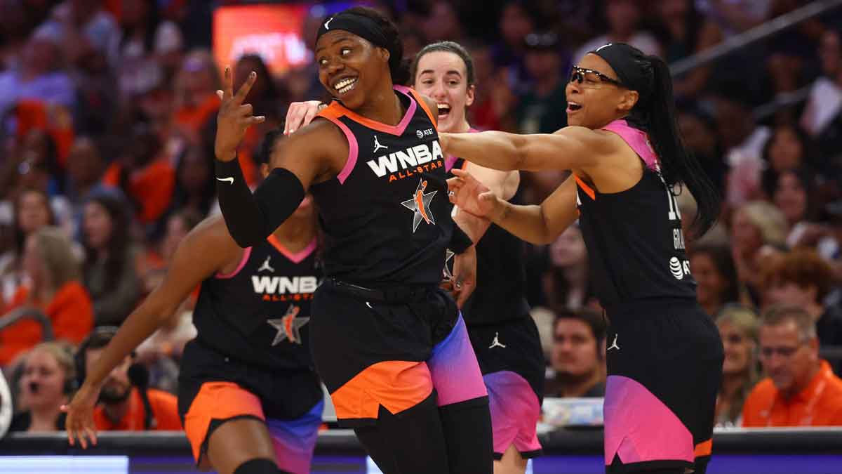 Team WNBA player Arike Ogunbowale celebrates with Caitlin Clark and Allisha Gray after making a three point shot during the second half against the USA Women's National Team at Footprint Center. 