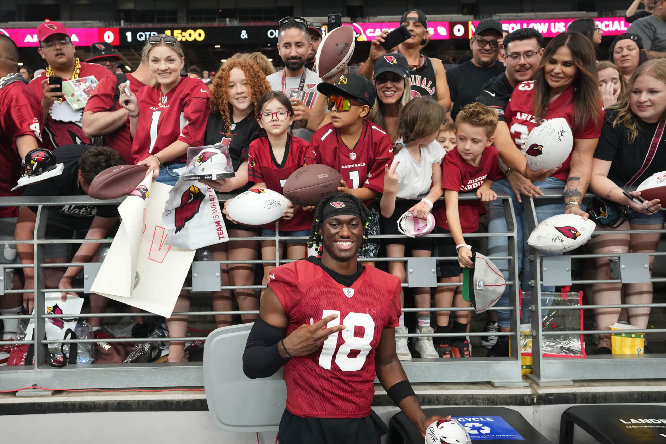 Arizona Cardinals receiver Marvin Harrison Jr. (18) takes photos with fans during training camp at State Farm Stadium in Glendale on July 28, 2024.