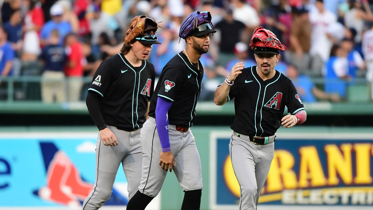 Arizona Diamondbacks center fielder Jake McCarthy (31), left fielder Lourdes Gurriel Jr. (12) and right fielder Corbin Carroll (7) celebrate after defeating the Boston Red Sox at Fenway Park.