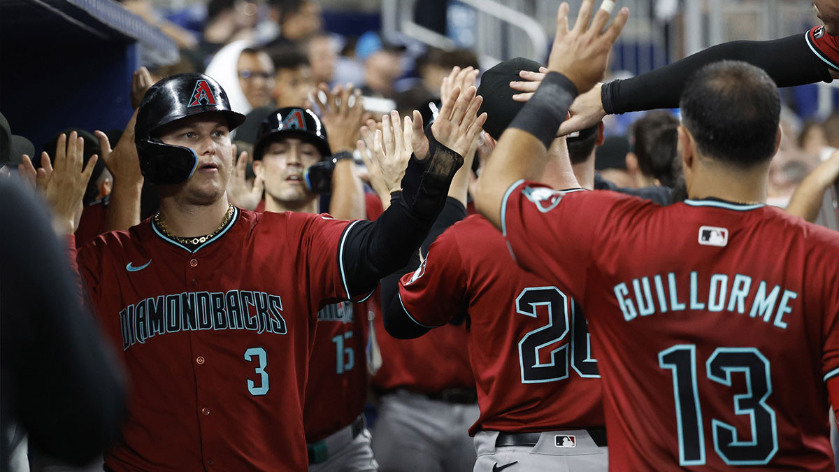 Arizona Diamondbacks designated hitter Joc Pederson (3) is greeted in the dugout by teammates after scoring against the Miami Marlins in the seventh inning at loanDepot Park.
