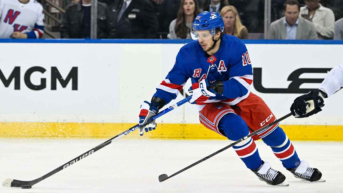 New York Rangers left wing Artemi Panarin (10) skates with the puck as Florida Panthers defenseman Brandon Montour (62) defends during the third period of game five of the Eastern Conference final of the 2024 Stanley Cup Playoffs at Madison Square Garden. 