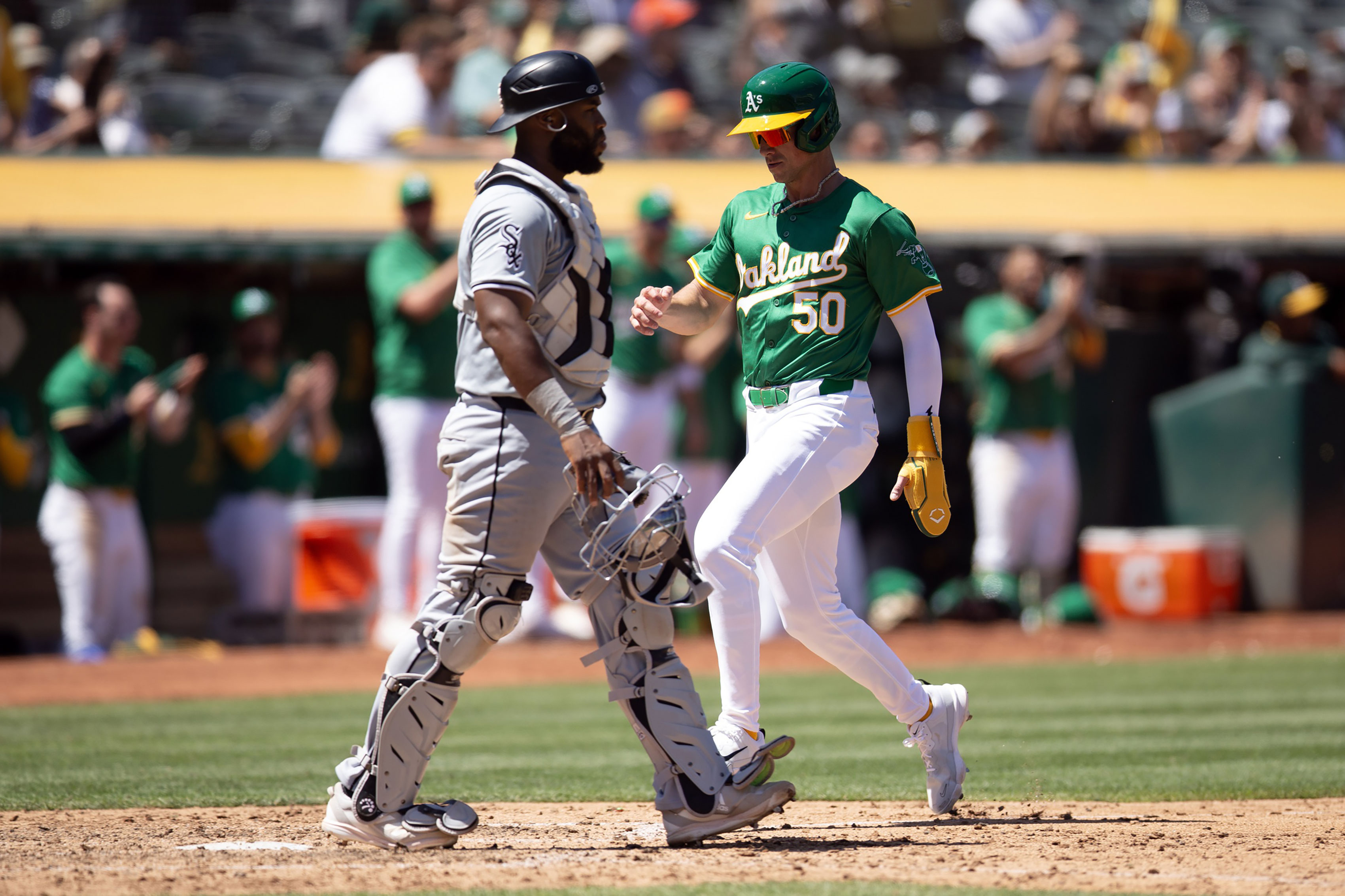 Oakland Athletics first baseman Armando Alvarez (50) scores the go-ahead run against Chicago White Sox catcher Chuckie Robinson (47) during the seventh inning at Oakland-Alameda County Coliseum.
