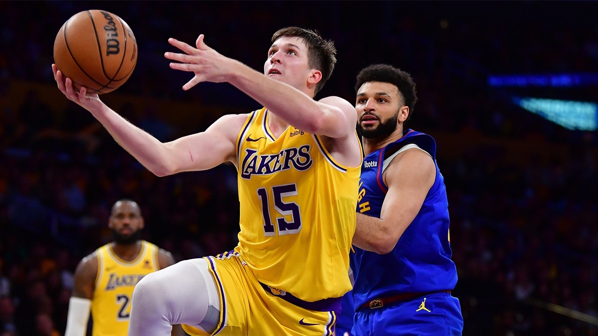 Austin Reaves (15) shoots ahead of Denver Nuggets guard Jamal Murray (27)