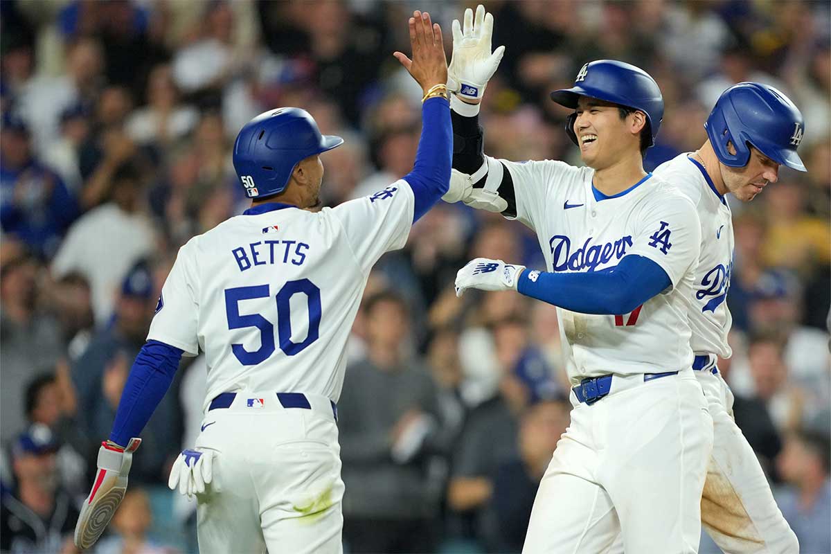 Jun 11, 2024; Los Angeles, California, USA; Los Angeles Dodgers designated hitter Shohei Ohtani (17) celebrates at home plate with shortstop Mookie Betts (50) after hitting a two-run home run in the sixth inning against the Texas Rangers at Dodger Stadium. at Dodger Stadium.