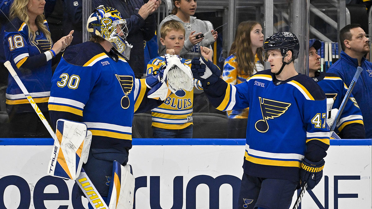 St. Louis Blues defenseman Torey Krug (47) is congratulated by goaltender Joel Hofer (30) after scoring against the Chicago Blackhawks during the first period at Enterprise Center.