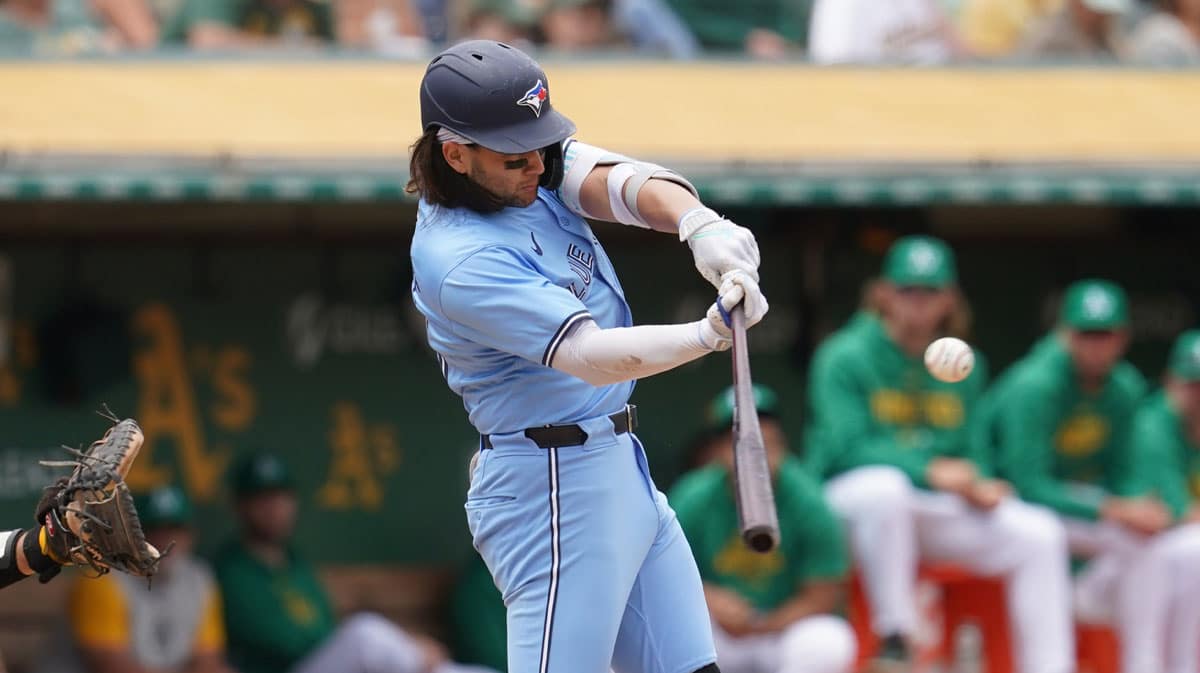 Jun 8, 2024; Oakland, California, USA; Toronto Blue Jays shortstop Bo Bichette (11) hits an RBI double against the Oakland Athletics in the fifth inning at Oakland-Alameda County Coliseum.