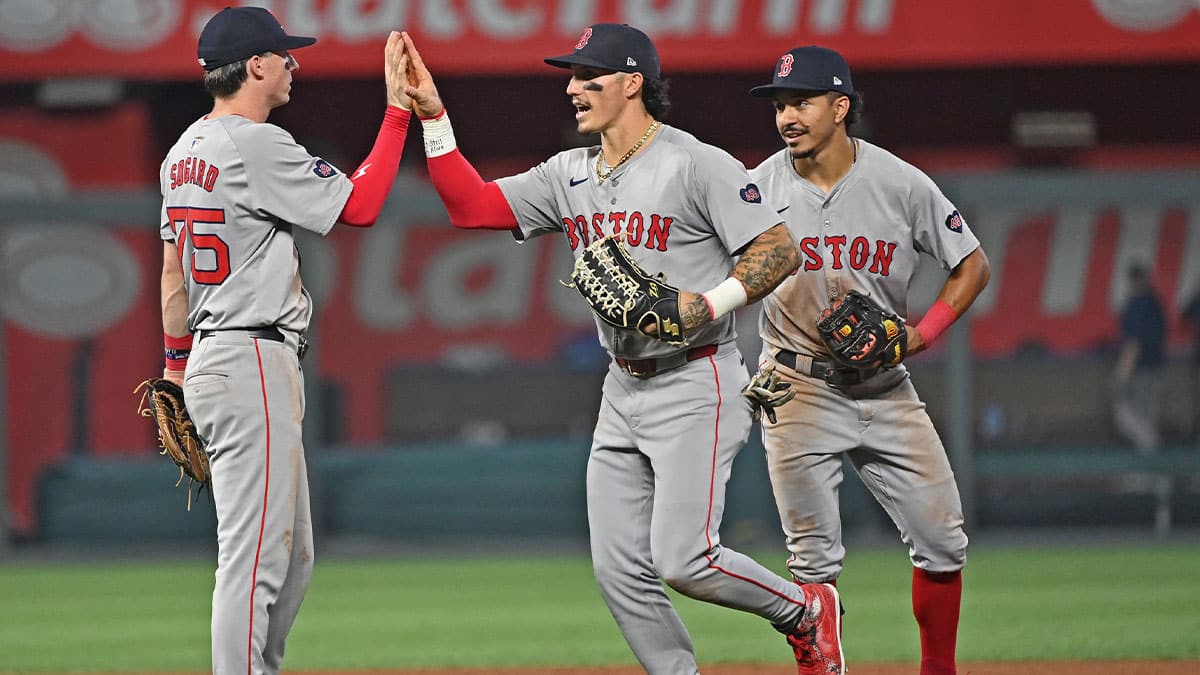 Aug 5, 2024; Kansas City, Missouri, USA; Boston Red Sox players Boston Red Sox left fielder Jarren Duran (center), second baseman Nick Sogard (left) and shortstop David Hamilton (right) celebrate after beating the Kansas City Royals at Kauffman Stadium. Mandatory Credit: Peter Aiken-USA TODAY Sports