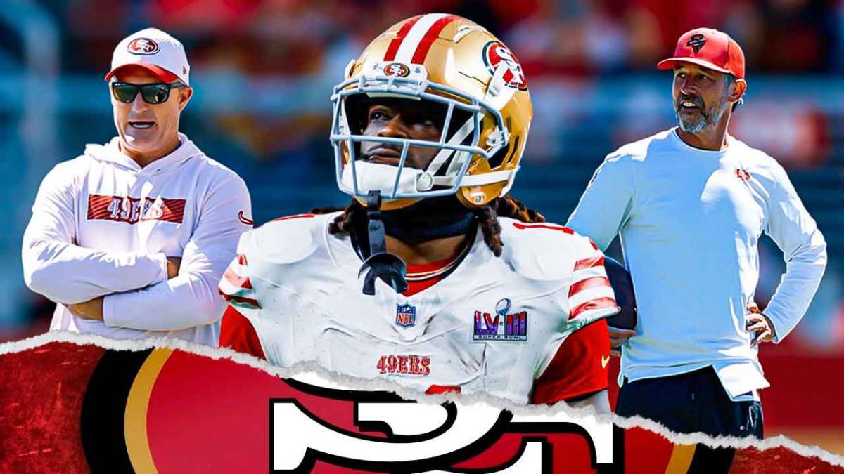 San Francisco 49ers star Brandon Aiyuk in the middle with John Lynch and Kyle Shanahan on either side in front of Levi's Stadium.