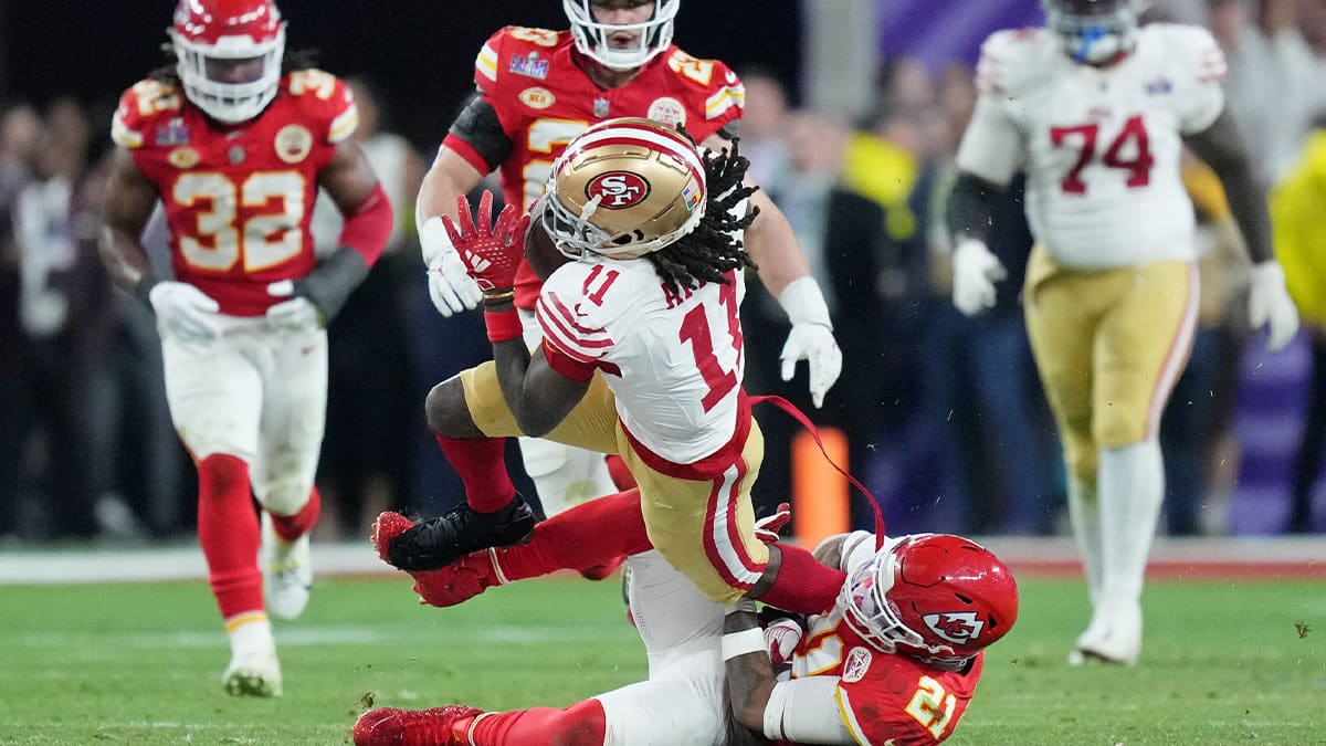 Kansas City Chiefs safety Mike Edwards (21) tackles San Francisco 49ers wide receiver Brandon Aiyuk (11) during overtime of Super Bowl LVIII at Allegiant Stadium.