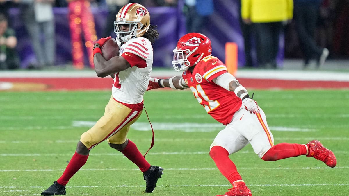 San Francisco 49ers wide receiver Brandon Aiyuk (11) makes a catch against Kansas City Chiefs safety Mike Edwards (21) during overtime of Super Bowl LVIII at Allegiant Stadium.