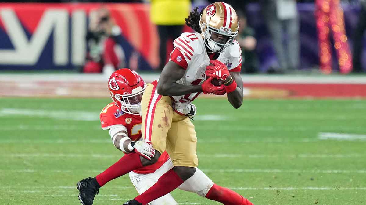 Kansas City Chiefs safety Mike Edwards (21) tackles San Francisco 49ers wide receiver Brandon Aiyuk (11) during overtime of Super Bowl LVIII at Allegiant Stadium.