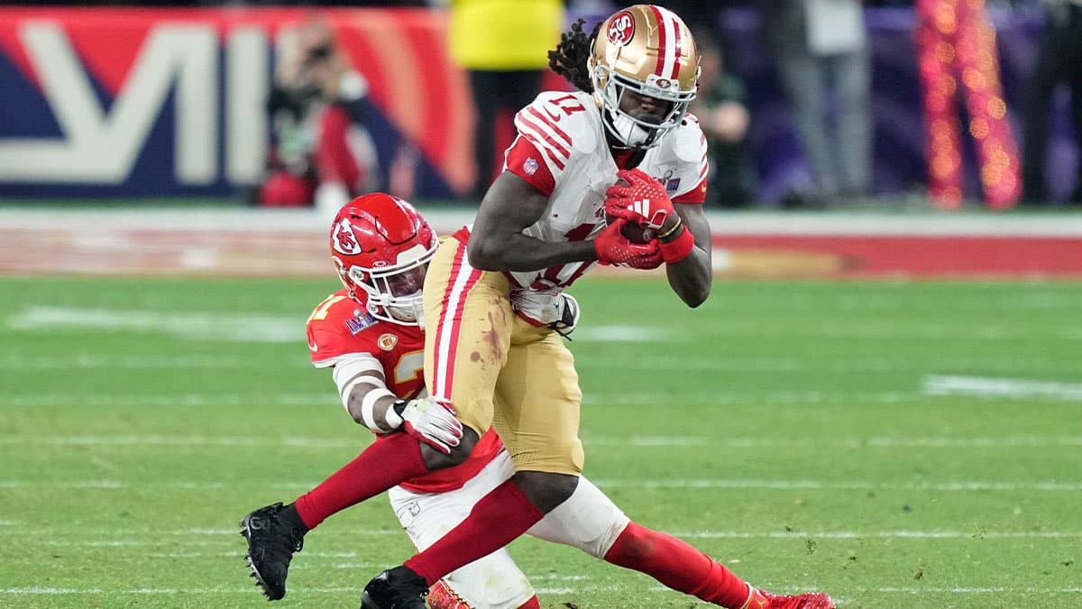 Kansas City Chiefs safety Mike Edwards (21) tackles San Francisco 49ers wide receiver Brandon Aiyuk (11) during overtime of Super Bowl LVIII at Allegiant Stadium.