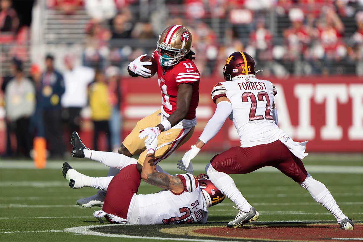 Washington Commanders cornerback Benjamin St-Juste (25) and safety Darrick Forrest (22) attempt to tackle San Francisco 49ers wide receiver Brandon Aiyuk (11) during the first quarter at Levi's Stadium.