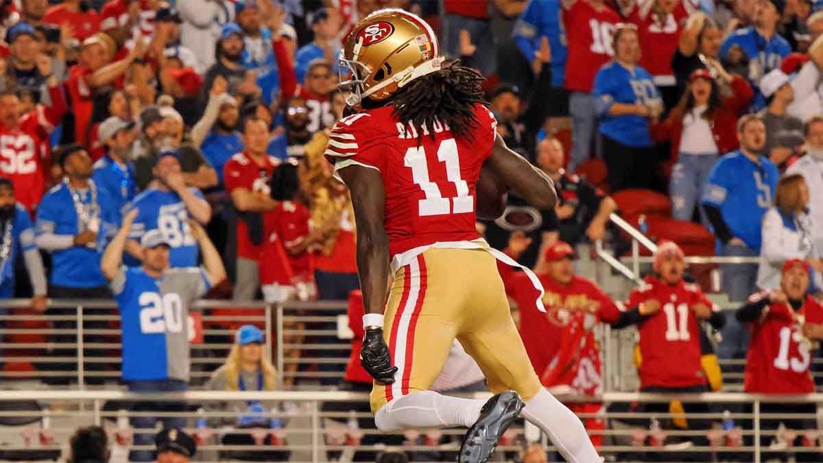 San Francisco 49ers wide receiver Brandon Aiyuk (11) reacts after catching a ball that bounced off the face mask of Detroit Lions cornerback Kindle Vildor (not pictured) during the second half of the NFC Championship football game at Levi's Stadium.