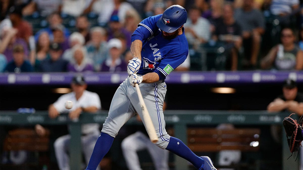 Sep 1, 2023; Denver, Colorado, USA; Toronto Blue Jays designated hitter Brandon Belt (13) hits a solo home run in the fourth inning against the Colorado Rockies at Coors Field. 