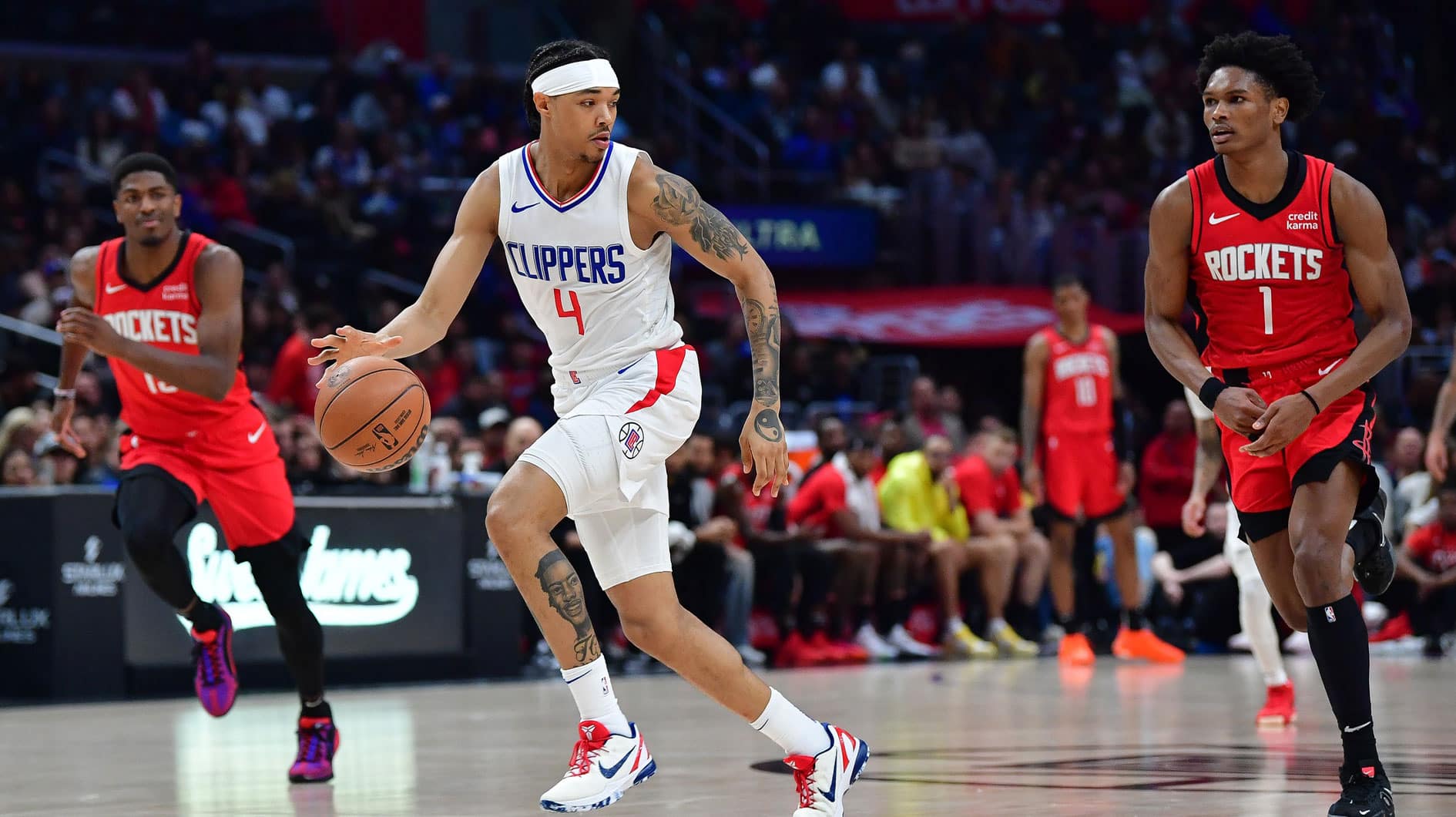 Los Angeles Clippers guard Brandon Boston Jr. (4) moves the ball ahead of Houston Rockets forward Amen Thompson (1) during the second half at Crypto.com Arena.