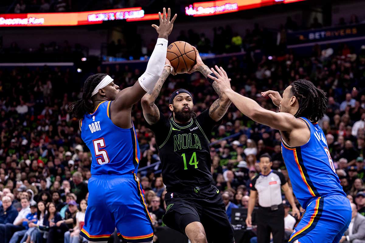 New Orleans Pelicans forward Brandon Ingram (14) dribbles against Oklahoma City Thunder guard Luguentz Dort (5) during the first half of game four of the first round for the 2024 NBA playoffs at Smoothie King Center. 