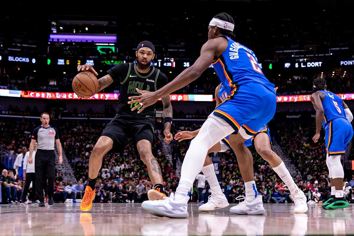 New Orleans Pelicans forward Brandon Ingram (14) dribbles against Oklahoma City Thunder guard Shai Gilgeous-Alexander (2) during game four of the first round for the 2024 NBA playoffs at Smoothie King Center.