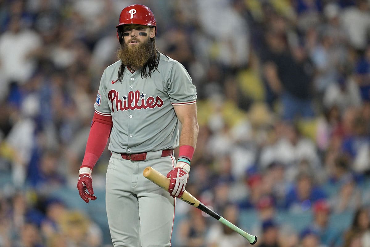 Philadelphia Phillies center fielder Brandon Marsh (16) walks back to the dugout after he was called out on strikes in the eighth inning against the Los Angeles Dodgers at Dodger Stadium. 