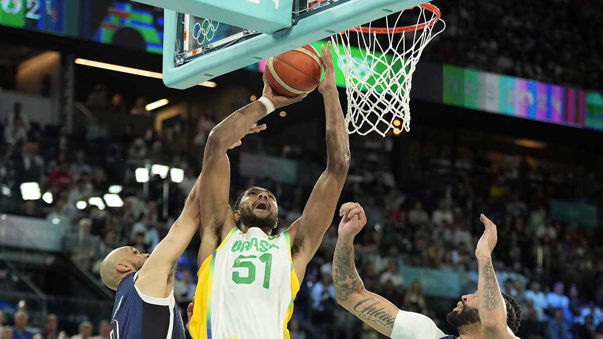 Brazil power forward Bruno Caboclo (51) shoots against United States guard Derrick White (8) and centre Anthony Davis (14) in the second half in a men’s basketball quarterfinal game during the Paris 2024 Olympic Summer Games at Accor Arena.