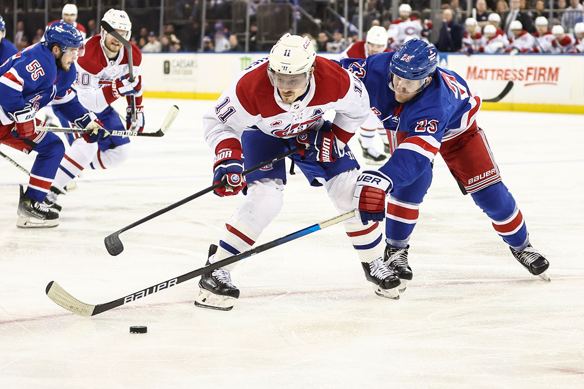 Montreal Canadiens right wing Brendan Gallagher (11) and New York Rangers defenseman Adam Fox (23) battle for control of the puck at Madison Square Garden.