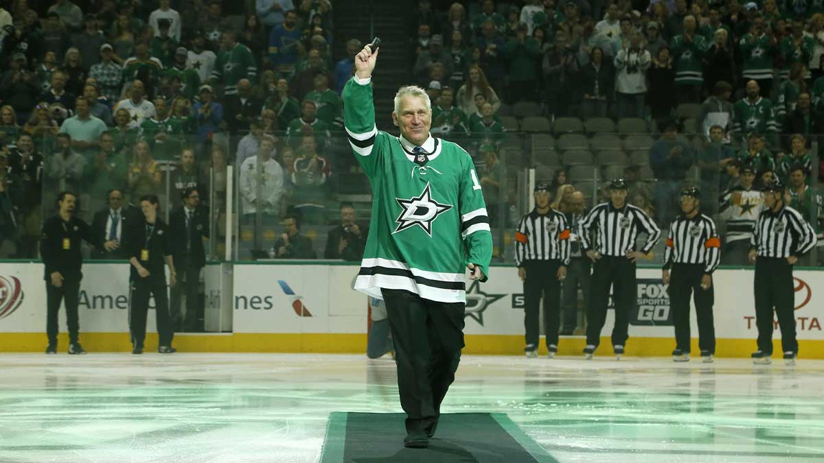 Dallas Stars and St. Louis Blues former player Brett Hull waves to the crowd after a ceremonial puck drop before the game at American Airlines Center.