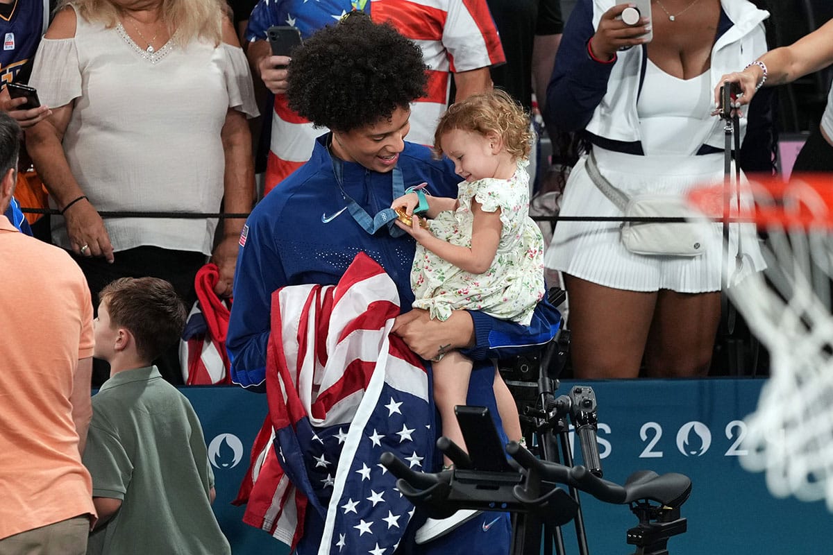 United States centre Brittney Griner (15) celebrates with Isla Taurasi, daughter of shooting guard Diana Taurasi, after defeating France in the women’s basketball gold medal game during the Paris 2024 Olympic Summer Games.