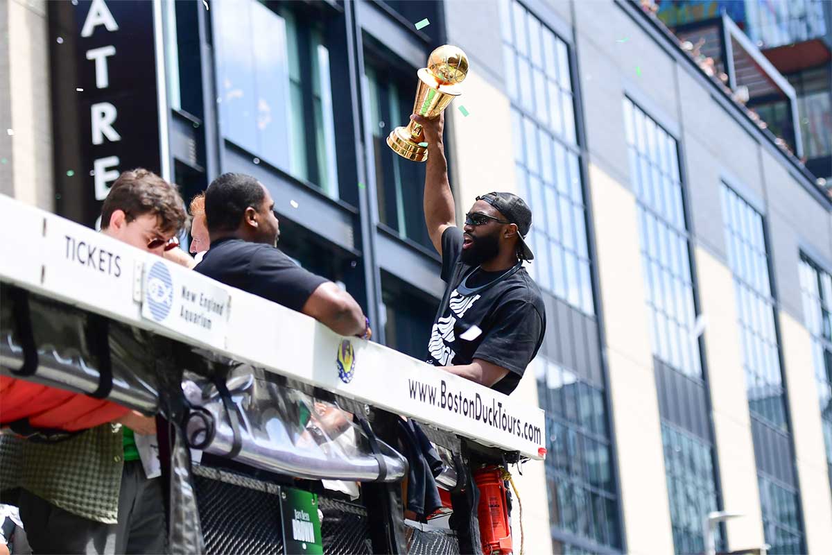 Boston Celtics player Jaylen Brown holds the MVP trophy during the Boston Celtics championship parade.