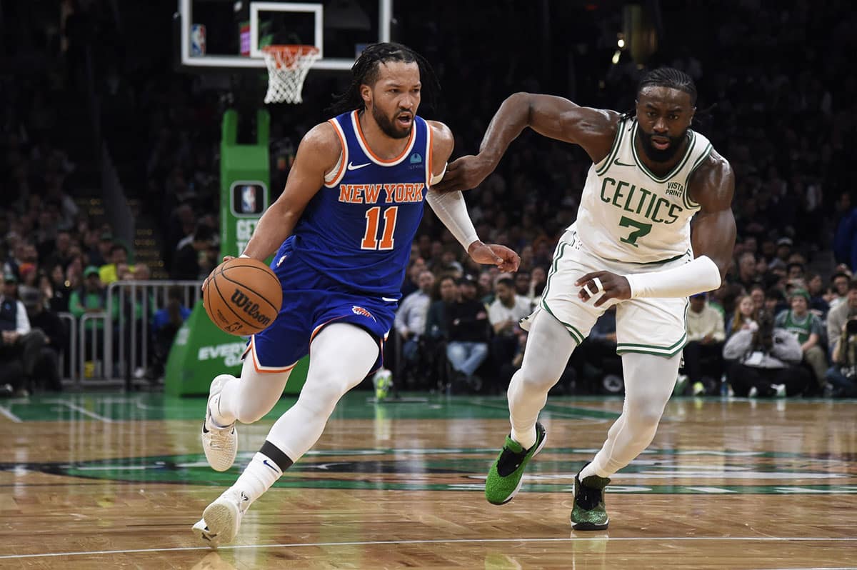 New York Knicks guard Jalen Brunson (11) controls the ball while Boston Celtics guard Jaylen Brown (7) defends during the first half at TD Garden. 