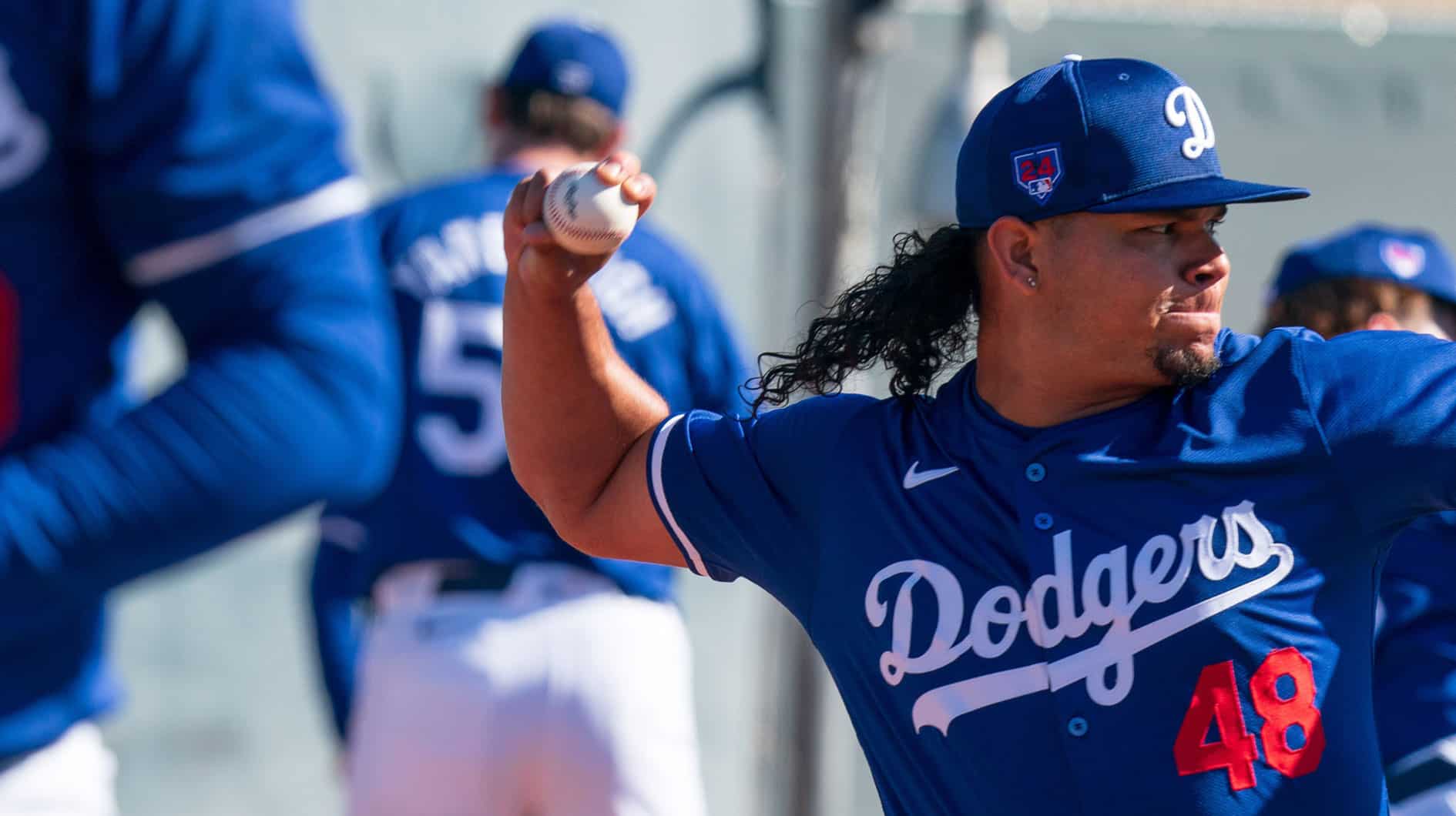  Los Angeles Dodgers pitcher Brusdar Graterol (48) works alongside members of his team on the practice mound at Camelback Ranch during Spring Training Workouts.