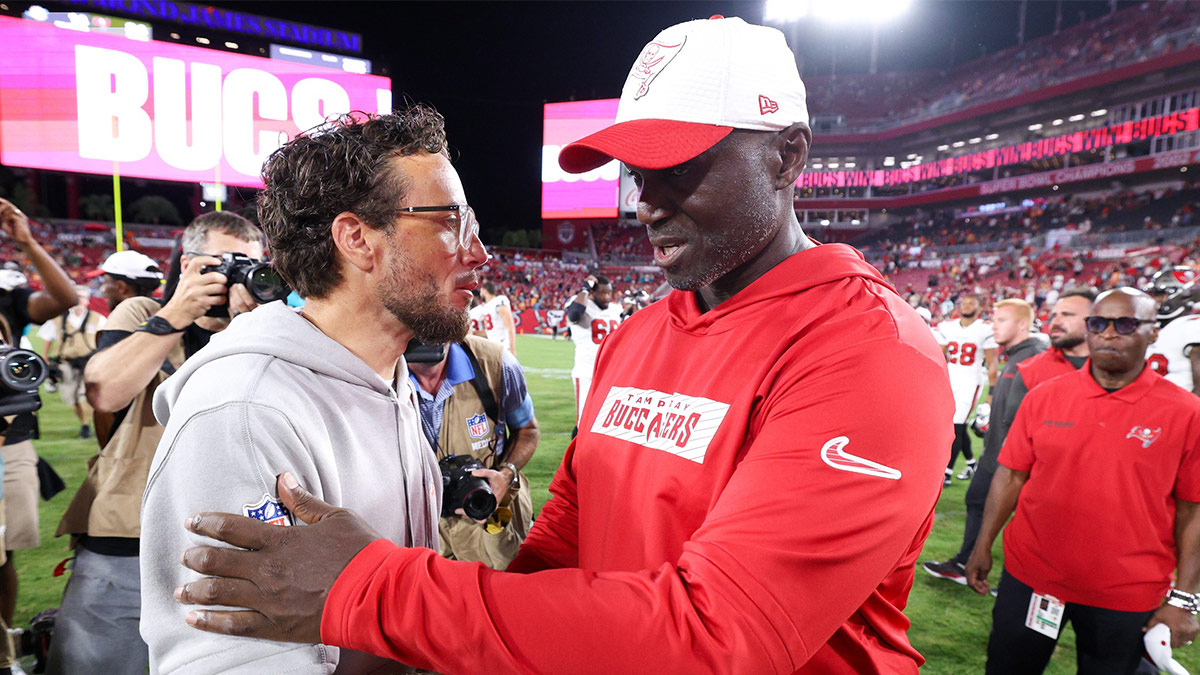Tampa Bay Buccaneers head coach greets Miami Dolphins head coach Mike McDaniel after a preseason game at Raymond James Stadium.