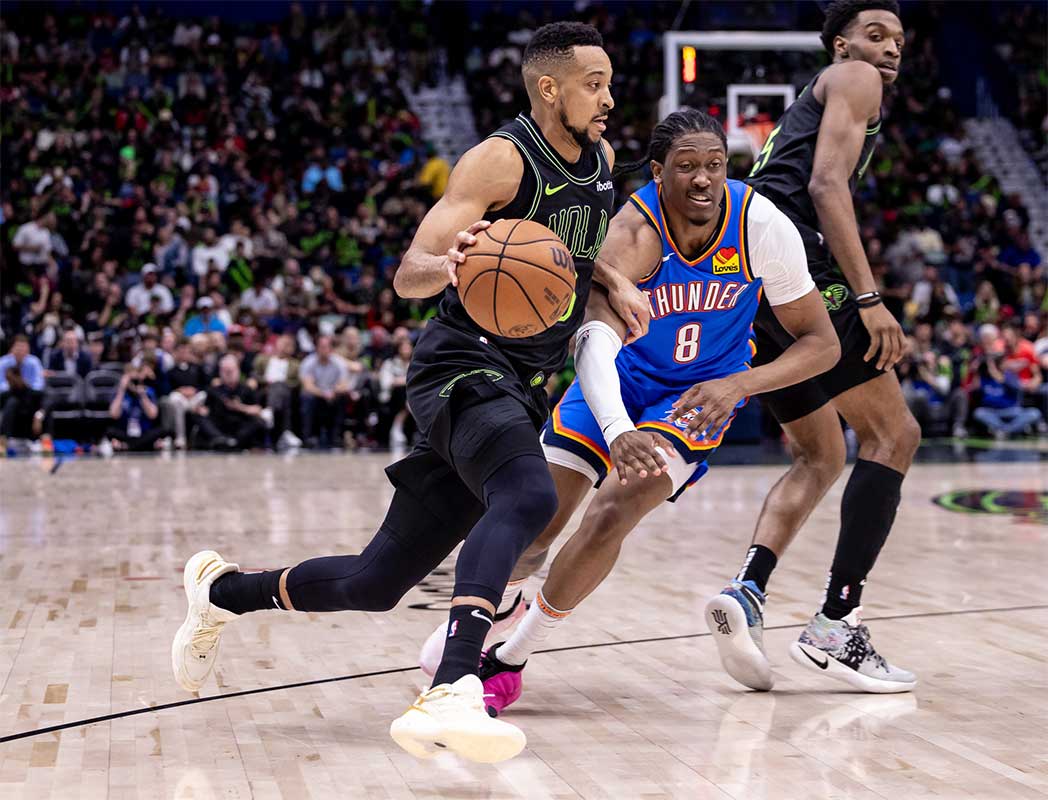 New Orleans Pelicans guard CJ McCollum (3) dribbles against Oklahoma City Thunder forward Jalen Williams (8) during the first half of game four of the first round for the 2024 NBA playoffs at Smoothie King Center