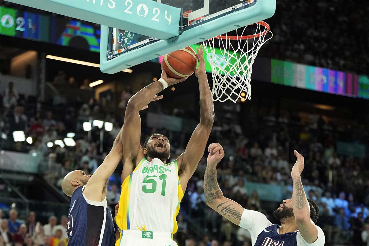 Brazil power forward Bruno Caboclo (51) shoots against United States guard Derrick White (8) and centre Anthony Davis (14) in the second half in a men’s basketball quarterfinal game during the Paris 2024 Olympic Summer Games at Accor Arena.