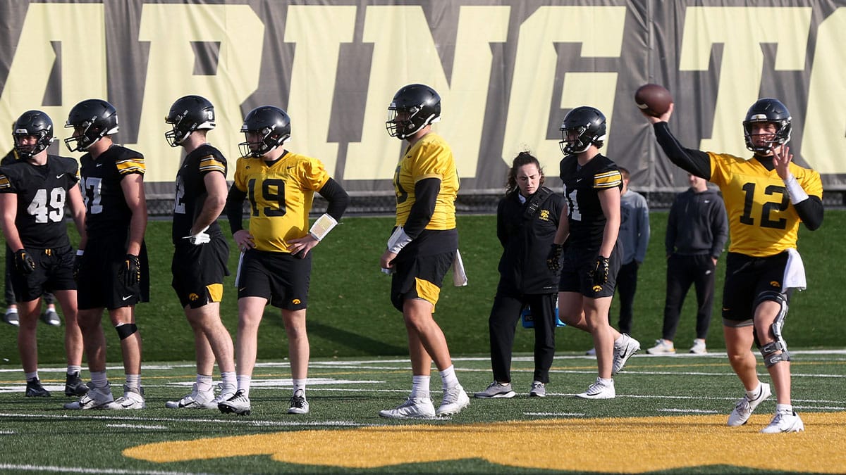 Iowa quarterback Cade McNamara (12) throws a pass during practice 