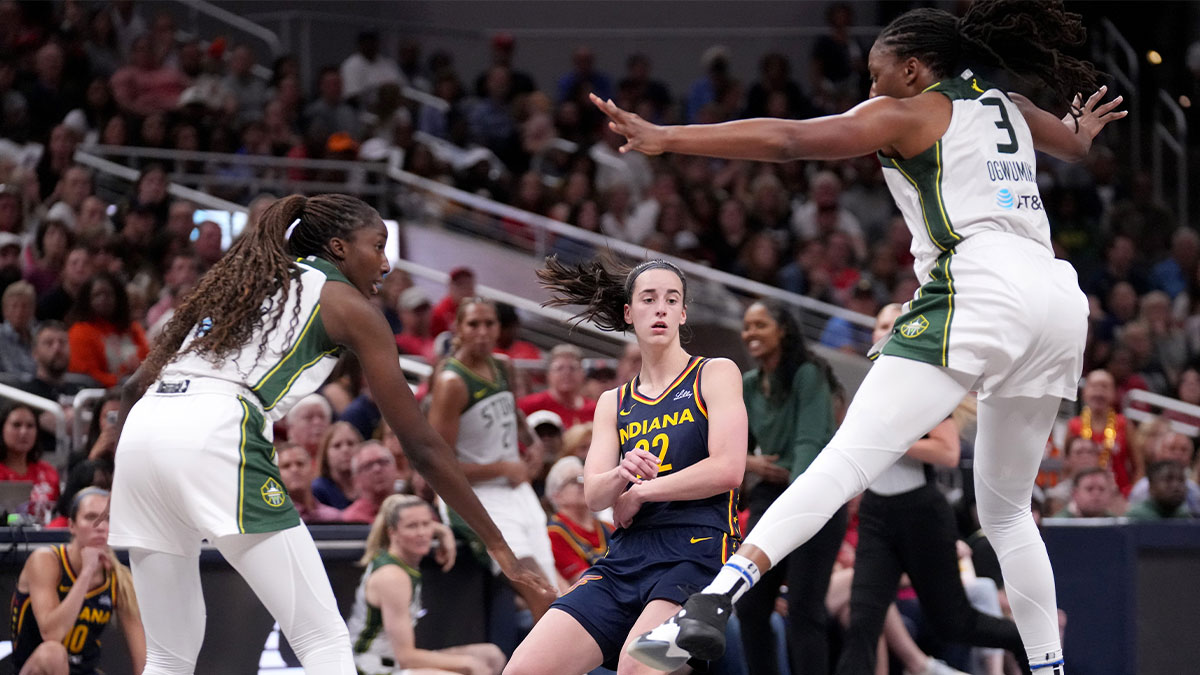 Seattle Storm center Ezi Magbegor (13) and forward Nneka Ogwumike (3) guard Indiana Fever guard Caitlin Clark (22) as she passes the ball during the second half of a game