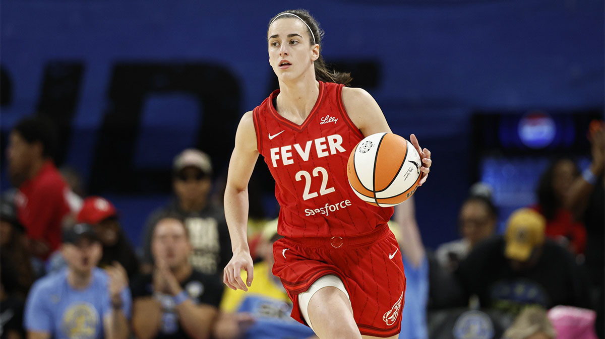 Indiana Fever guard Caitlin Clark (22) brings the ball up court against the Chicago Sky during the first half at Wintrust Arena.