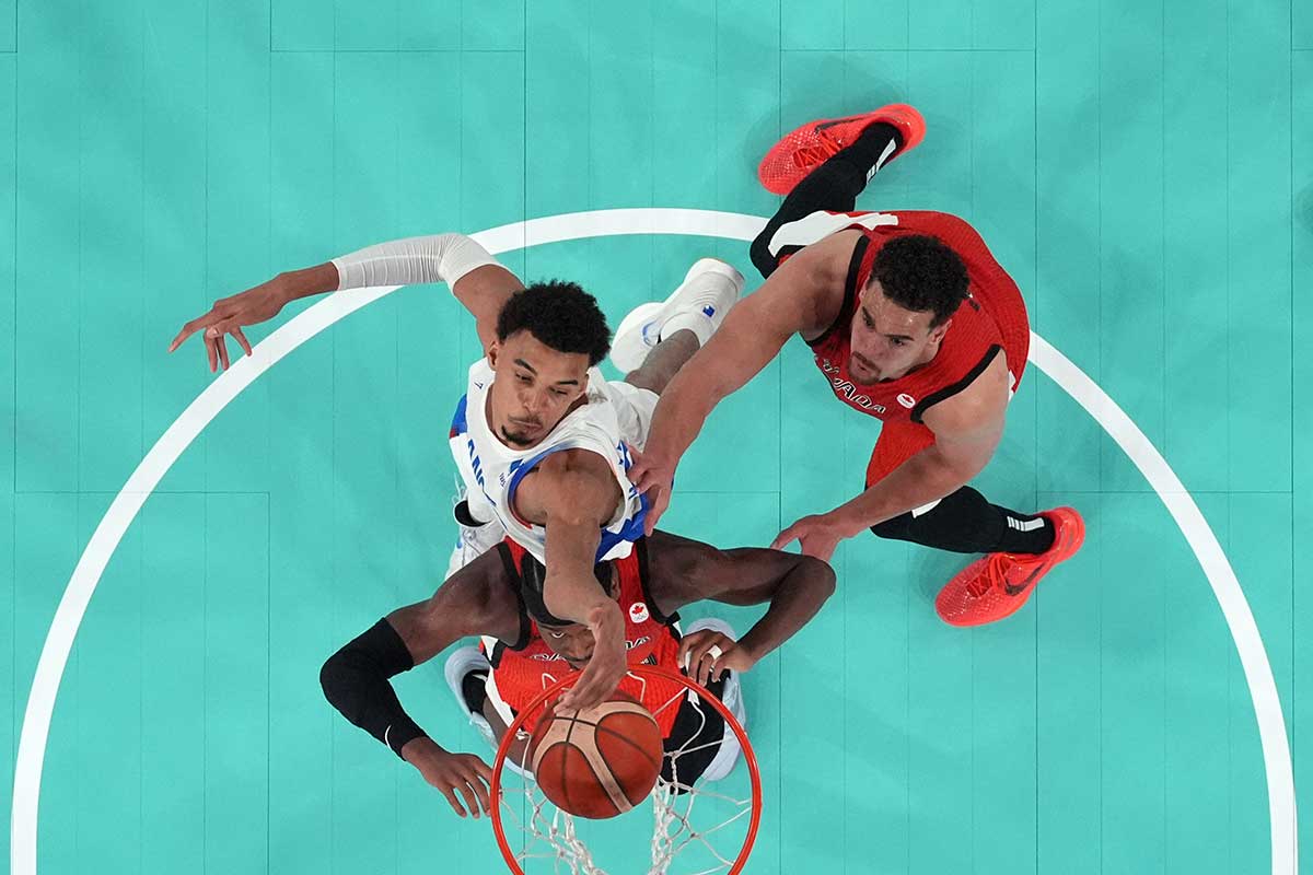 Canada guard Shai Gilgeous-Alexander (2) shoots against France power forward Victor Wembanyama (32) in the second half in a men’s basketball quarterfinal game during the Paris 2024 Olympic Summer Games at Accor Arena