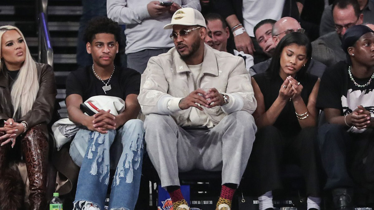 Former NBA player Carmelo Anthony (r) sits with his son Kiyan Anthony (l) at the game between the Boston Celtics and the New York Knicks at Madison Square Garden.