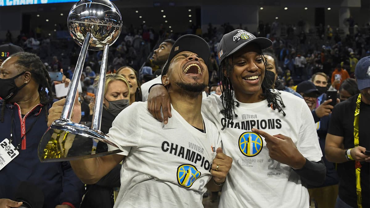 Chicago Sky guard Diamond DeShields, right, and Chance the Rapper hold the championship trophy after the Chicago Sky beat the Phoenix Mercury 80-74 in game four of the 2021 WNBA Finals at Wintrust Arena.
