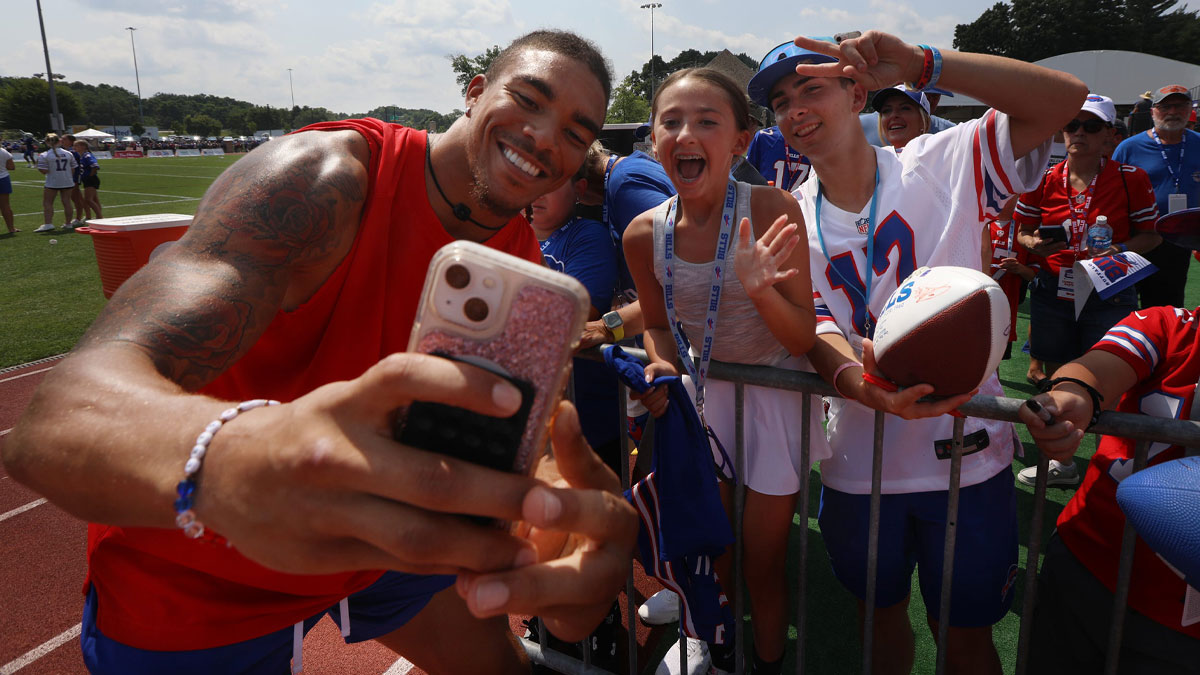 Bills Chase Claypool uses Isabella Napora's phone to take a photo of them together with her brother, Cameron Rider, after Bills training camp.