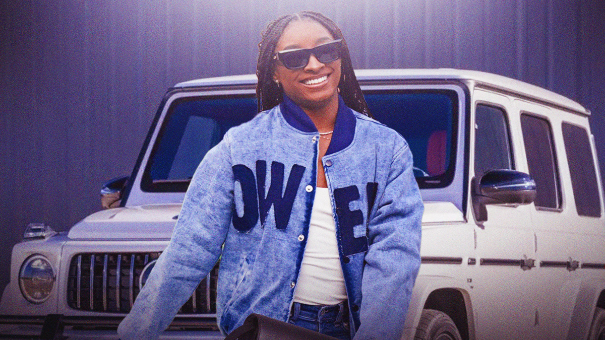 Simone Biles in front of a car from her collection.